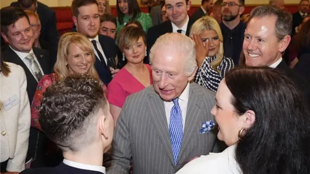 King Charles speaks to guests during a reception at Buckingham Palace on Wednesday