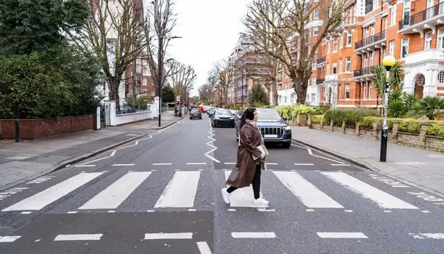 Une femme traverse la chaussée