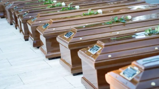 Di coffins of 26 teenage migrants wey rescuers see dia dead bodi on top Mediterranean Sea for November 2017. Nigerian girls dey among di people wey die as dem dey try cross sea go Europe.