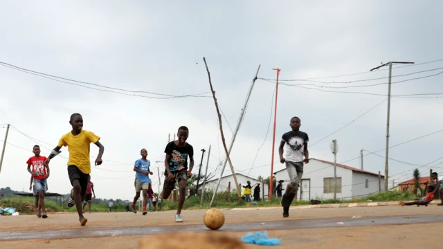 Children playing football on the streets of Soweto, South Africa - Tuesday 18 January 2022