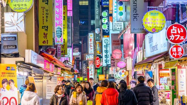 Crowds enjoy the Myeong-Dong district at night.