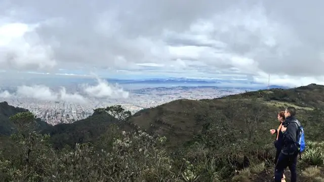 Pareja mira la ciudad desde los cerros.