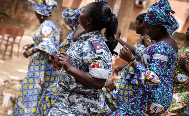 Female wardens and female detainees dance together at a prison in Ouagadougou, Burkina Faso - Tuesday 8 March 2022