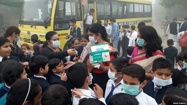 Teachers distributing masks