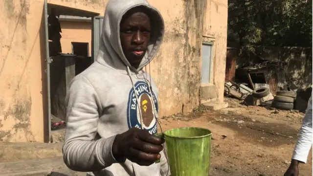 Young man hold cup of hot water