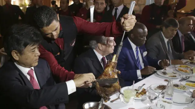 China's Ambassador to Brazil, Li Jinzhang, left, sits next to Brazil's President Michel Temer during a steak dinner at a traditional Brazilian barbecue restaurant after a meeting on the rotten meat scandal in Brasilia, Brazil, Sunday, March 19, 2017.