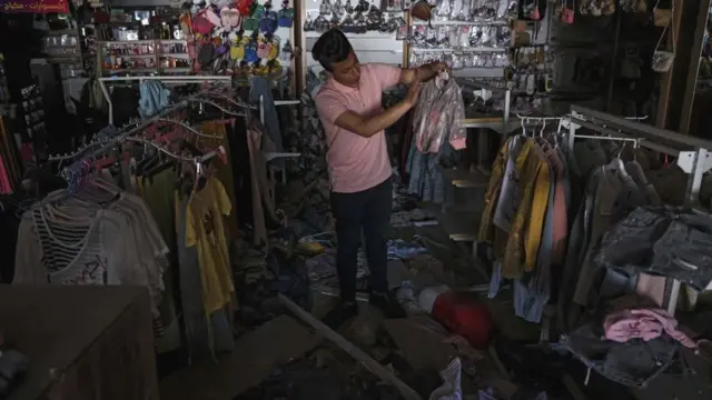 दुकान में सफ़ाई करता एक फ़लस्तीनी