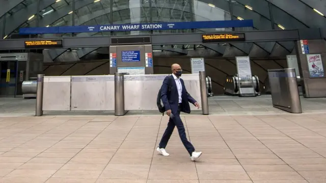 Lone commuter at Canary Wharf station