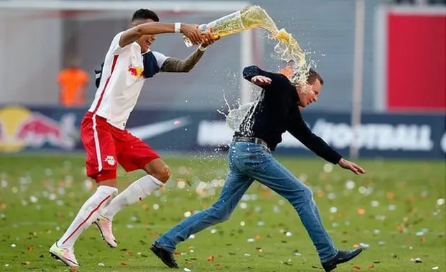 Rangnick, pictured celebrating RB Leipzig's 2016 promotion to the Bundesliga, chased by a player pouring beer over his head