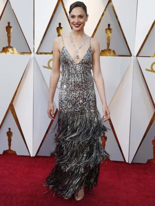 Wonder Woman actress Gal Gadot wears a strappy silver Givenchy couture dress on the Oscars red carpet