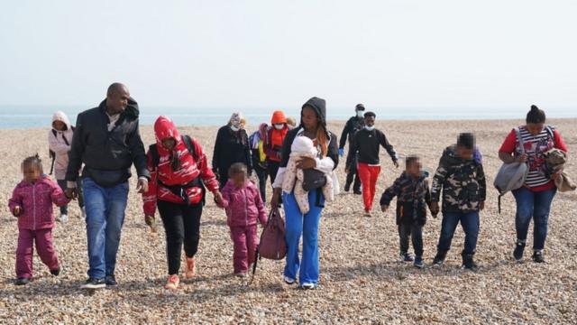Adults and children on the beach