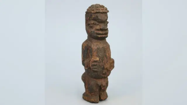 Small carved wooden male figure, listed as originating from the ‘Benin West Africa Expedition 1897’.
