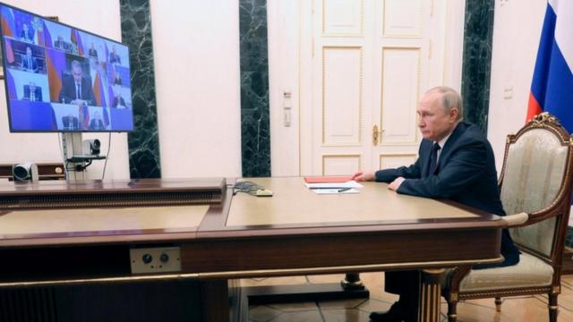 Russian President Vladimir Putin chairs a meeting with members of the Security Council via a video link at the Kremlin