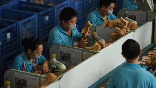Workers on a production line at the Huajian shoe factory in Dongguan, in southern China's Guangdong province (14 September 2016)
