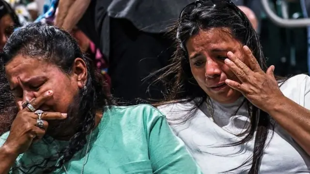 People cry at the vigil in Texas