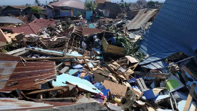People search through debris in a residential area following an earthquake and tsunami in Palu, Central Sulawesi, Indonesia September 30, 2018