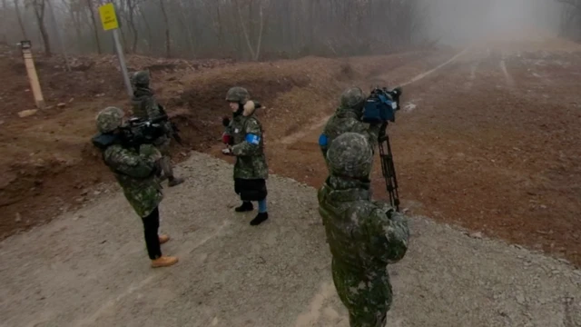 남북이 연결한 첫 '군사도로'에서 취재 중인 외신 기자단. 북측 땅이 안개로 자욱하다