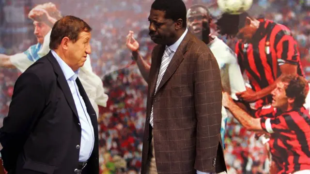 Pape Diouf in front of a board depicting Marseille's 1993 European Cup win over AC Milan