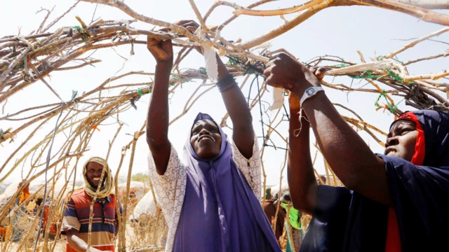 People creating a makeshift shelter at a displacement camp outside Baradere, Somalia - Sunday 13 March 2022