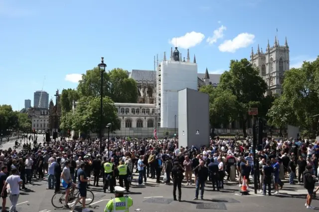 People in Parliament Square, London, before a possible protest by the Democratic Football Lads Alliance against a Black Lives Matter protest
