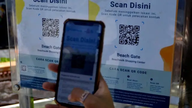 Pengunjung memindai QR Code dengan aplikasi PeduliLindungi saat hari pertama pembukaan mal di Beachwalk Shopping Center, Kuta, Badung, Bali, Rabu (8/9/2021)