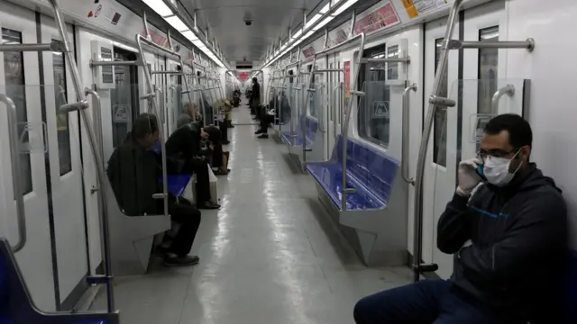 People wear protective face masks on a metro train in Tehran, Iran (17 March 2020)