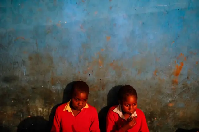 Children look on in a classroom during their lunch break at Fruitful Rescue Centre