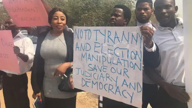 Lawyers carry placard