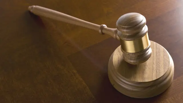 Gavel resting on wood table