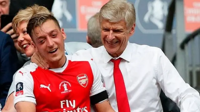 Mesut Ozil and Arsene Wenger celebrate winning the FA Cup