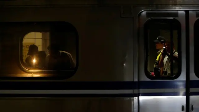 Policemen check a train after an explosion at the Songshan train station in Taipei, Taiwan