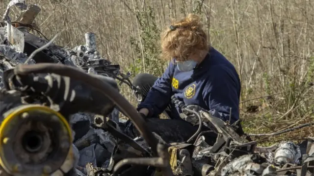 An investigator works at the scene of the helicopter crash that killed former NBA star Kobe Bryant