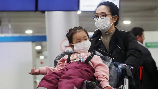 Mujer y niña con mascarillas.