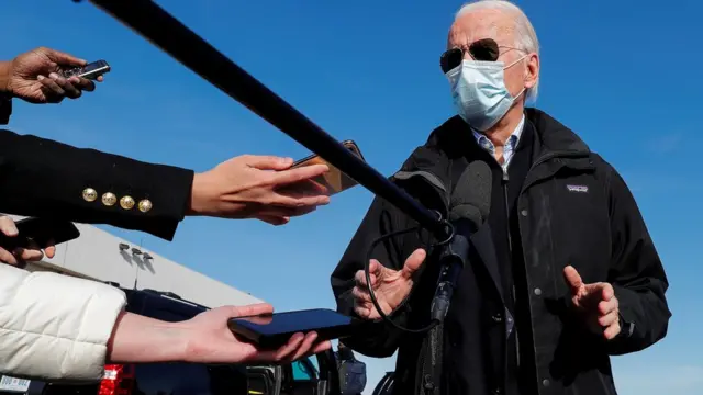 Joe Biden speaks to reporters as he departs Wilmington for travel to Georgia at New Castle Airport in New Castle, Delaware, 15 December