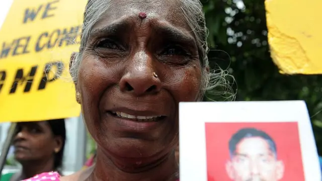 A group of women hold up images of their family members who had disappeared during the civil war with the Liberation Tigers of Tamil Eelam (LTTE) at a silent protest to commemorate the international day of the disappeared in Colombo on August 30, 2016. United Nation Secretary General Ban Ki Moon is scheduled to be in Sri Lanka for a three day official visit from August 31, and he will visit former war zone of Jaffna to meet war displaced people
