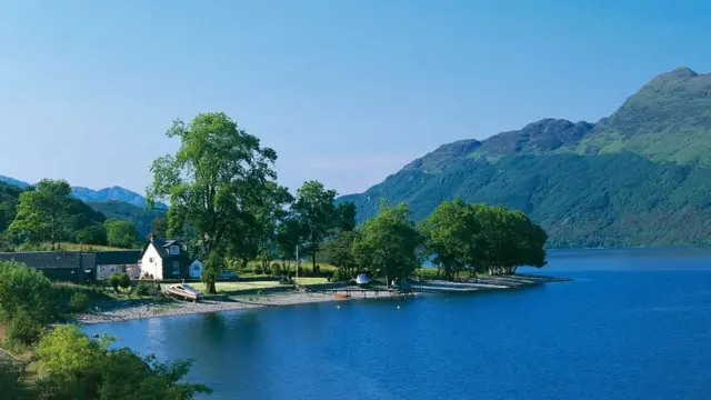 View of a cottege on the banks of Loch Lomond near Luss, Highlands, Scotland