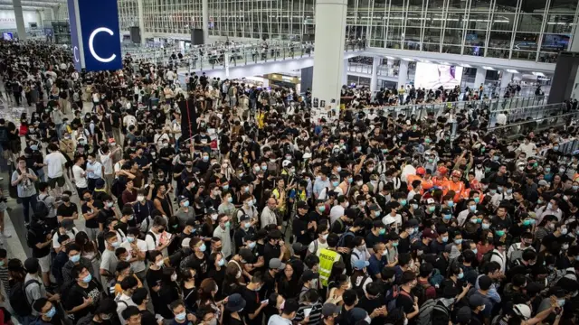 Protesters stage a sit-in at Hong Kong International Airport on 13 August 2019
