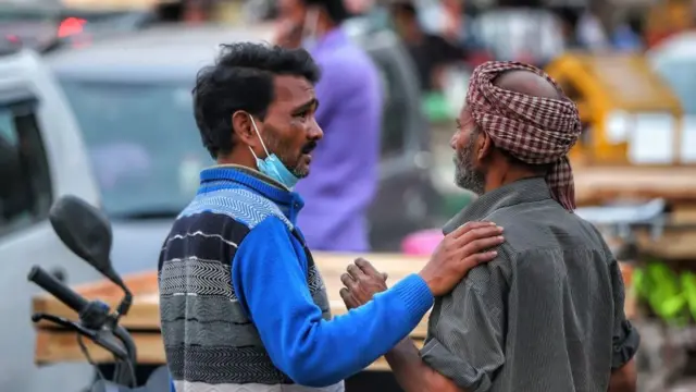 Labourers in conversation in Old Delhi India amid Covid-19 Coronavirus Pandemic on 11 March 2021.