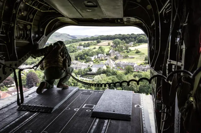 An RAF Chinook Mk6a helicopter approaches the Toddbrook Reservoir dam