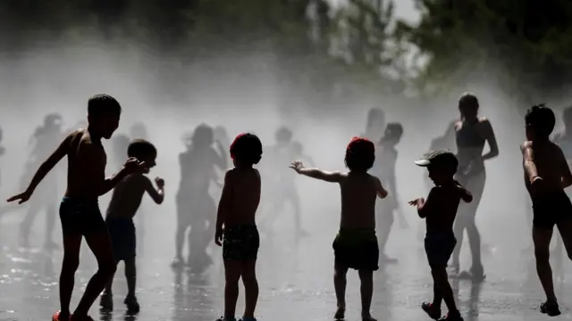 Children play in a fountain during a hot summer day, in Madrid, Spain, 25 June 2019