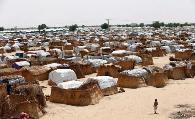 A girl walks through makeshift sheds at an internally displaced persons (IDP) camp on the outskirts of Maiduguri, northeast Nigeria June 6, 2017.