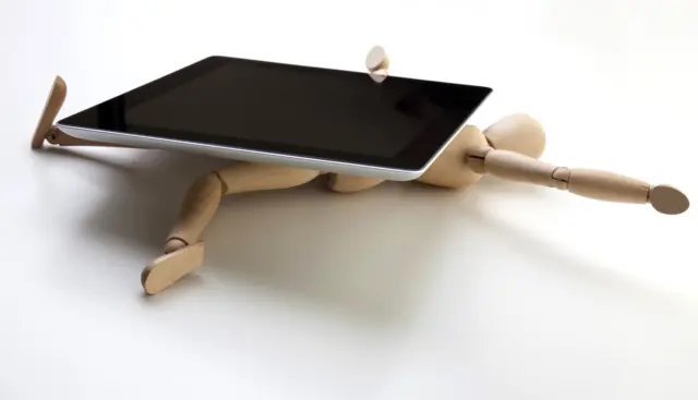 Concept photo - a mannequin being crushed by a with tablet