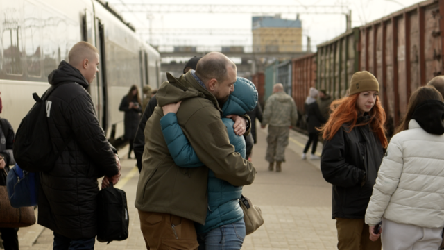 Two people hug at Kramatorsk train station