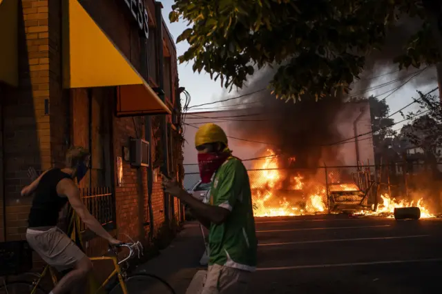 13. Cars burn during protests resulting from the killing of an unarmed black man, George Floyd, by police.