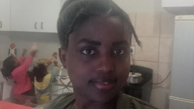 Alida at home with her children in the background