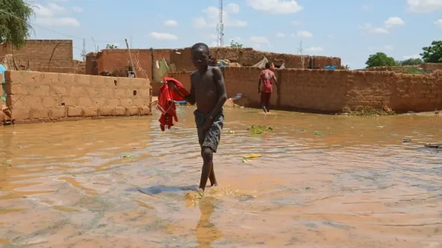 Wani yaro yana tafiya cikin ruwa a wani layi da ke Kirkissoye a Yamai.