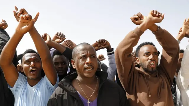 African asylum seekers protest against the detention of 18 asylum seekers who were imprisoned after refusing to leave the country, outside Holot detention facility near the Israeli-Egyptian border in southern Israel, 22 February 2018