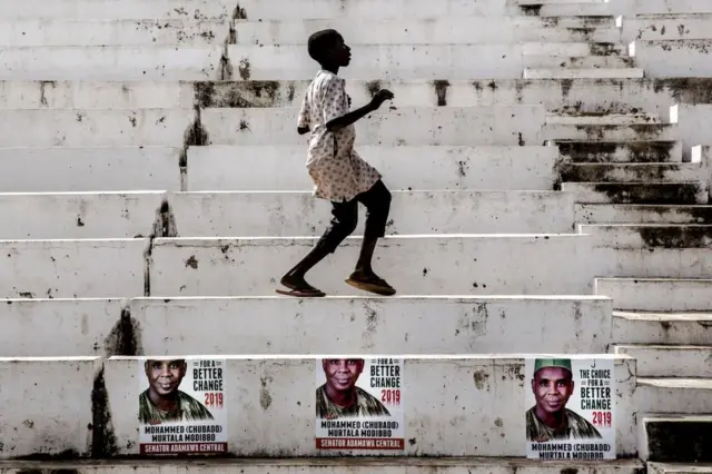 A boy dances at Ribadu Square, Jimeta, Adamawa State, Nigeria where the opposition Peoples Democratic Party (PDP) is set to hold a rally, on February 14, 2019. Nigerians will cast ballots on February 16 in presidential and legislative elections.