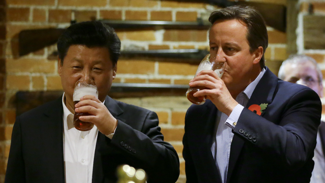China's President Xi Jinping and former prime minister David Cameron drink a pint of beer during his state visit to the UK in 2015