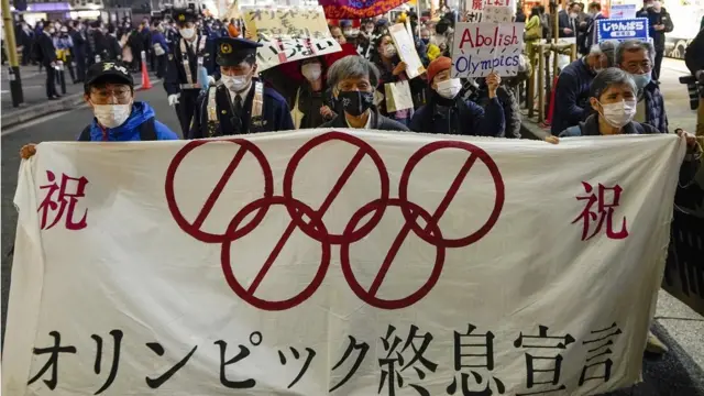 Demonstrators march though Shimbashi streets to protest against the start of torch relay of the Tokyo 2020 Olympic Games in Tokyo, Japan, 25 March 2021 after the torch relay of the Olympics started in Fukushima, northern Japan. Demonstrators shouted "Stop the torch relay. Stop the Olympics." during the protest